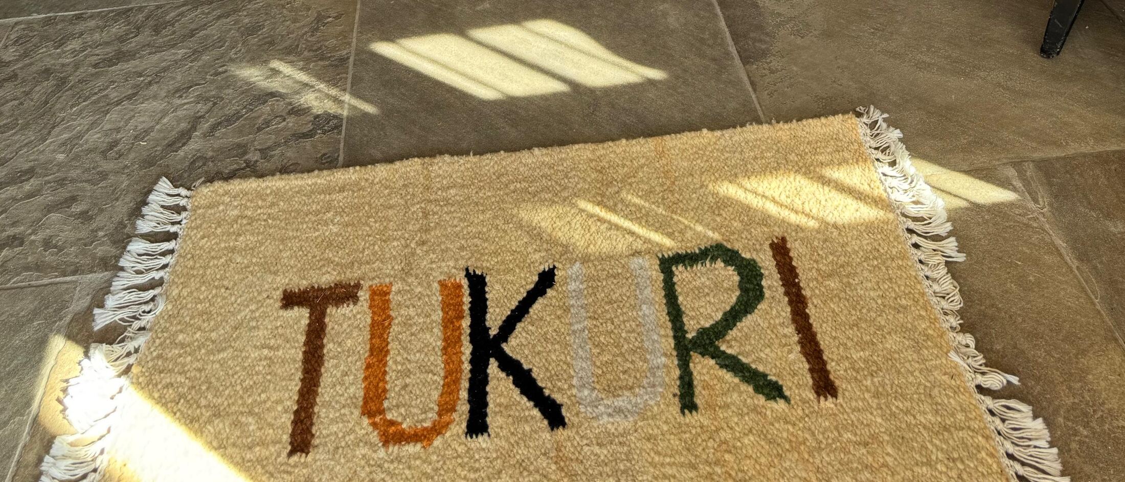 Woven Tukuri rug on a stone floor
